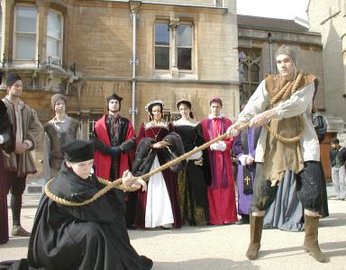 Thomas Cranmer, Edwardian Archbishop of Canterbury (Ned Dalby), guard and cast in background